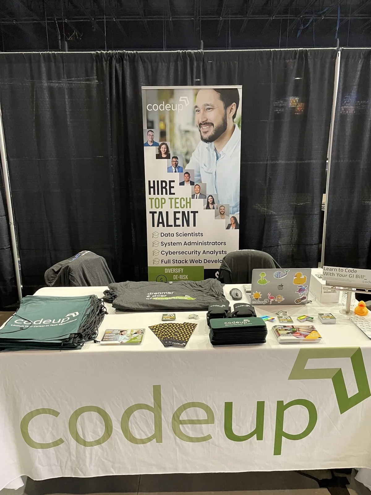 Codeup employer-marketing booth and hiring banner