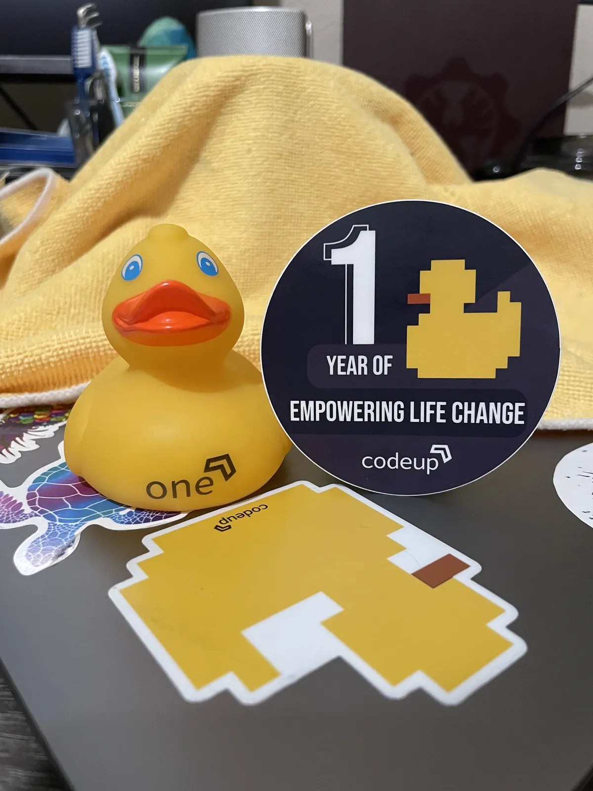 Codeup anniversary swag featuring a rubber duck and stickers