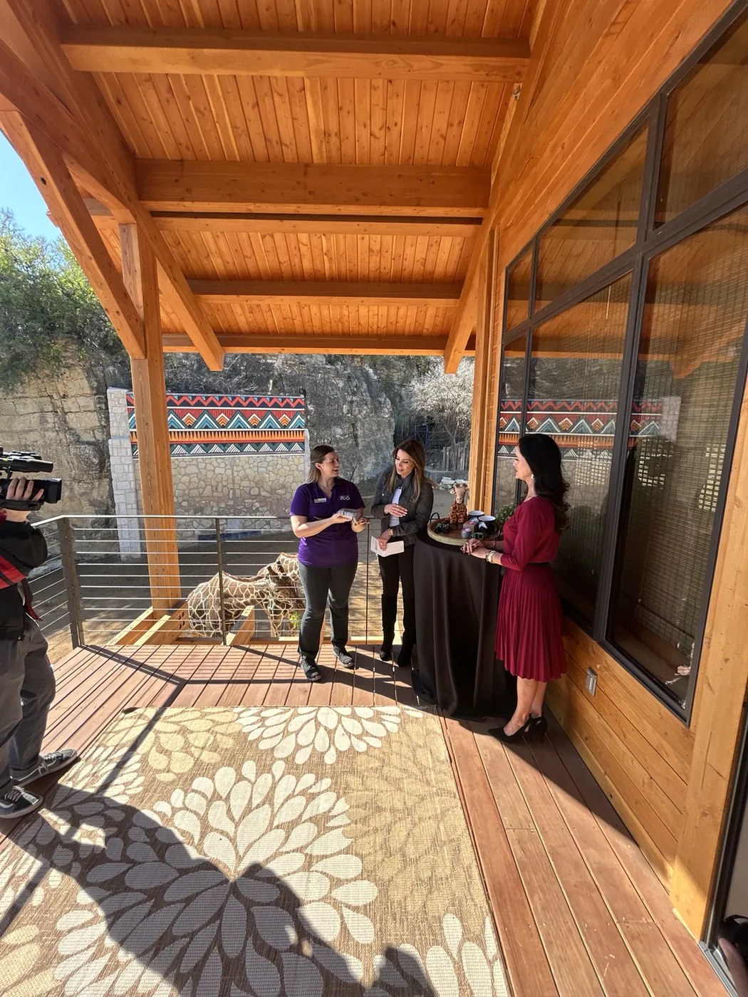News crew filming a giraffe segment at San Antonio Zoo